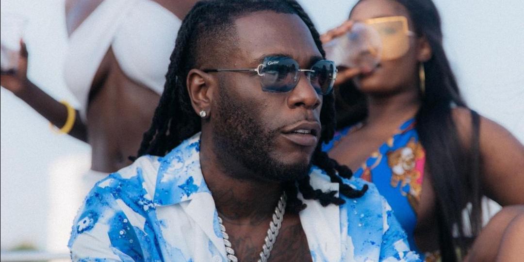 Singer Burna Boy gifts his grandma a designer handbag